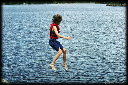 My son jumping into Kawnipi Lake