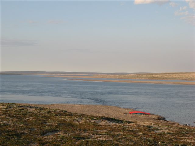 Red_canoes_on_pebble_beach.jpg